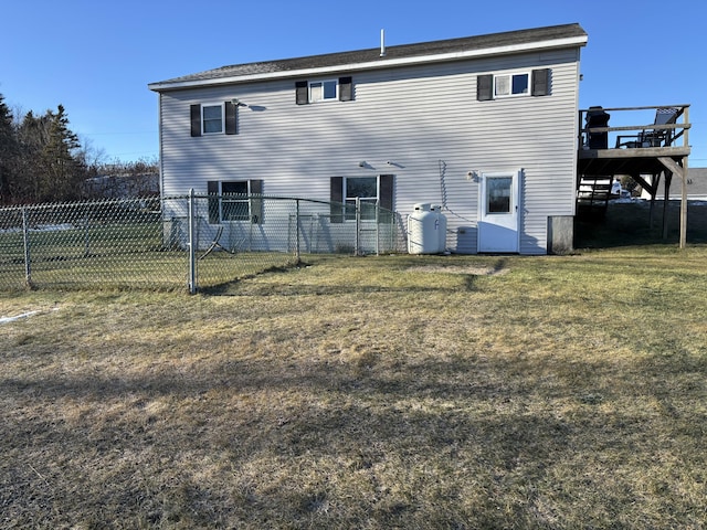 back of house featuring a yard and a deck