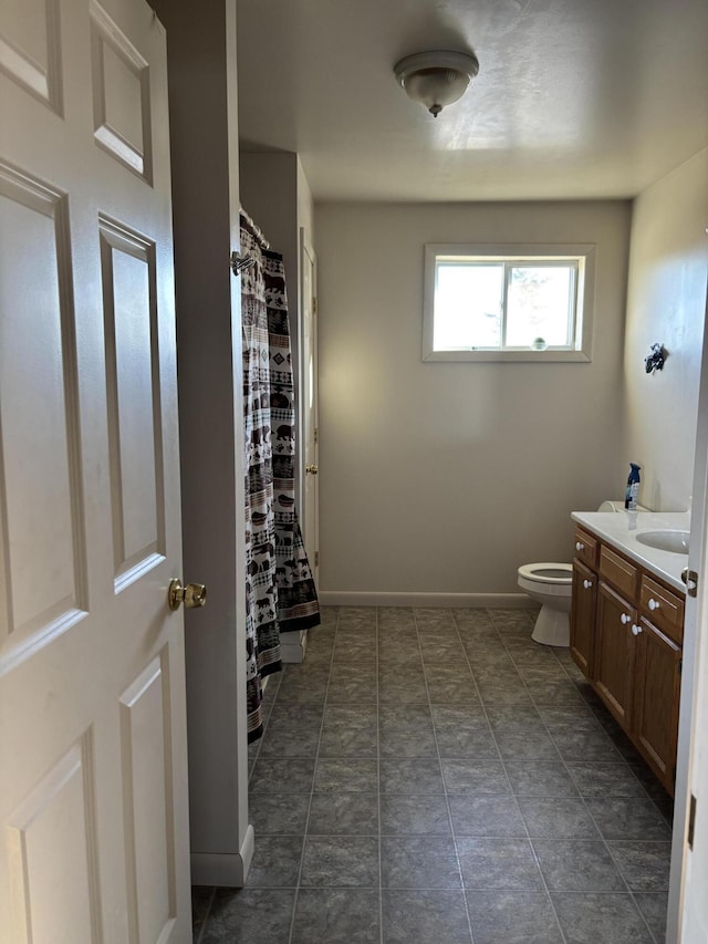 bathroom featuring vanity, toilet, and walk in shower