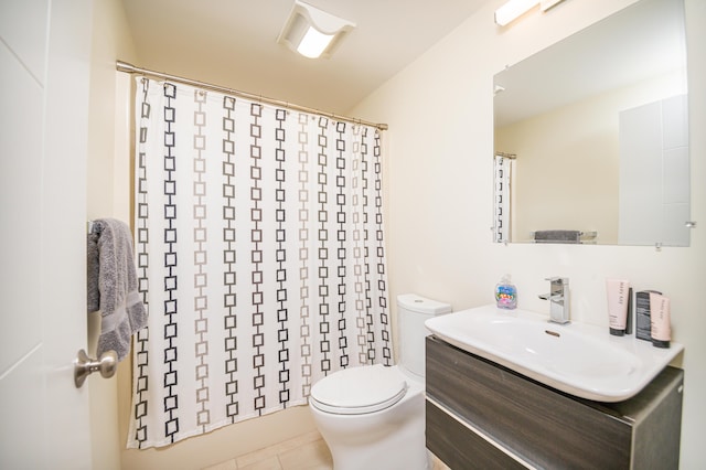 bathroom featuring tile patterned floors, vanity, toilet, and curtained shower