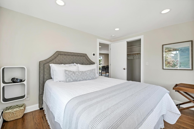 bedroom featuring dark hardwood / wood-style flooring and a closet