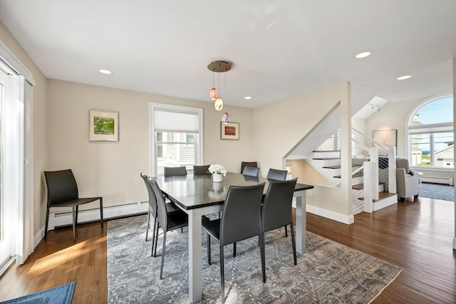 dining area featuring baseboard heating and dark wood-type flooring