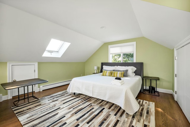 bedroom with hardwood / wood-style floors, a baseboard radiator, and lofted ceiling