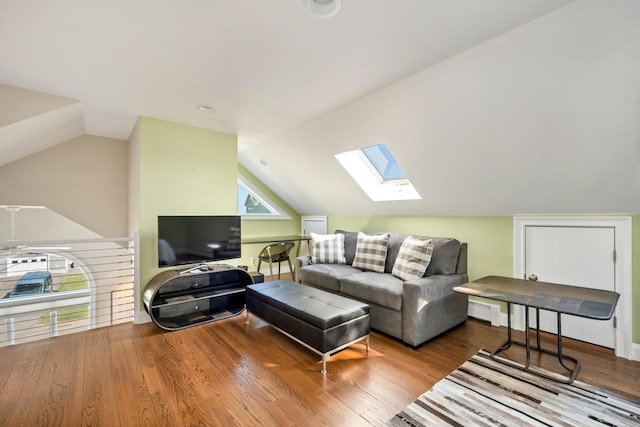 living room featuring wood-type flooring and vaulted ceiling