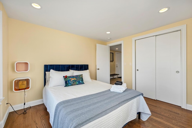 bedroom with hardwood / wood-style flooring and a closet