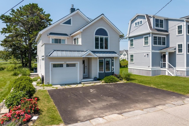 view of property featuring a front lawn and a garage