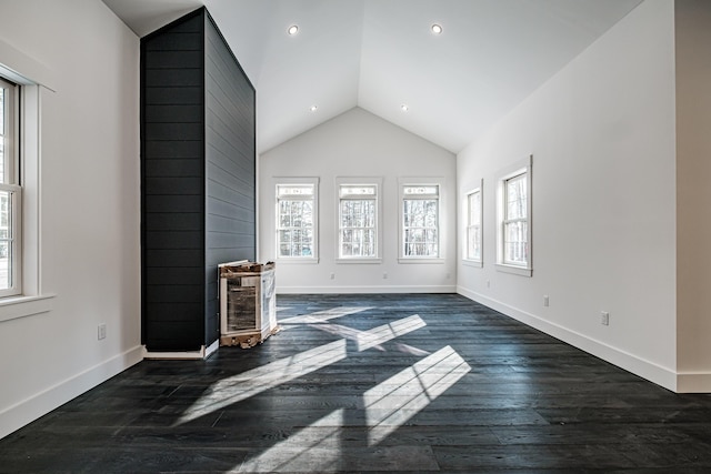 unfurnished living room featuring dark hardwood / wood-style floors and vaulted ceiling