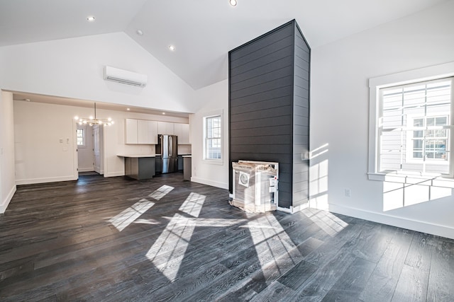 unfurnished living room featuring dark hardwood / wood-style flooring, high vaulted ceiling, a wall unit AC, and a notable chandelier