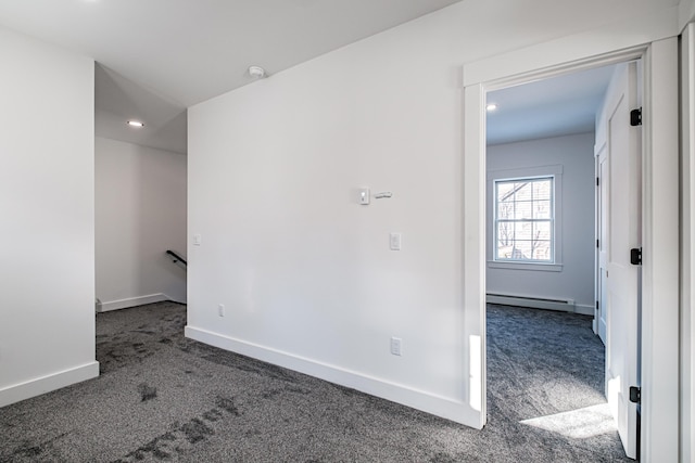 carpeted empty room with baseboard heating