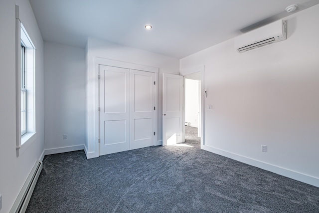 unfurnished bedroom featuring dark colored carpet, a closet, an AC wall unit, and a baseboard radiator