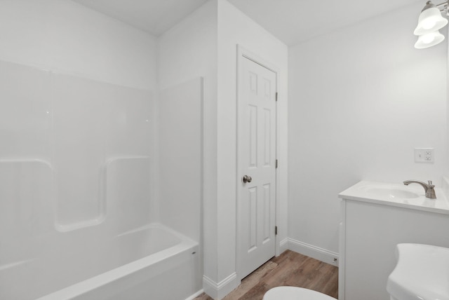 full bathroom featuring shower / bathing tub combination, wood-type flooring, vanity, and toilet