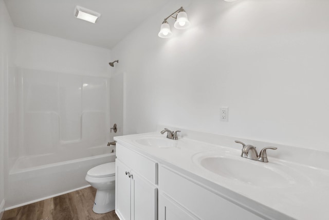 full bathroom featuring vanity, wood-type flooring, shower / bathtub combination, and toilet