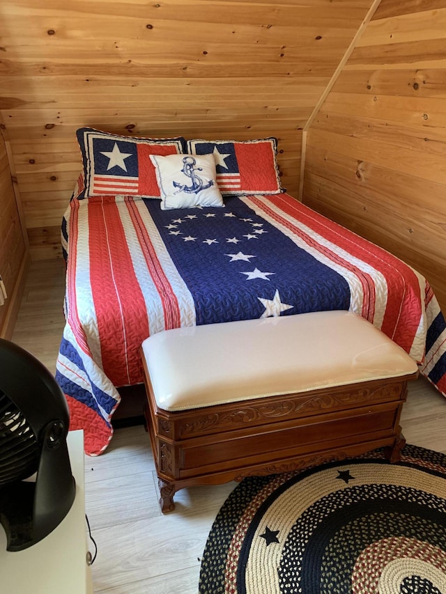 bedroom featuring wooden walls, wooden ceiling, and hardwood / wood-style flooring