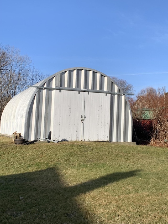 view of outdoor structure with a lawn