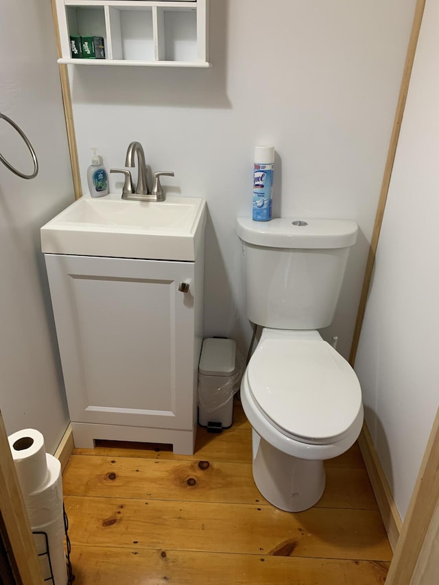 bathroom with vanity, toilet, and wood-type flooring