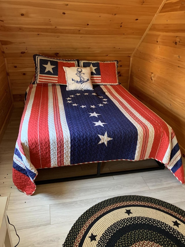 unfurnished bedroom featuring wood walls, wood-type flooring, and wood ceiling