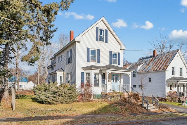 view of front property with a front yard and a porch