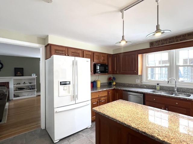 7 Edgewood Dr, Orono, ME 04473 - kitchen with white fridge with ice dispenser, stainless steel dishwasher, a sink, black microwave, and light stone countertops