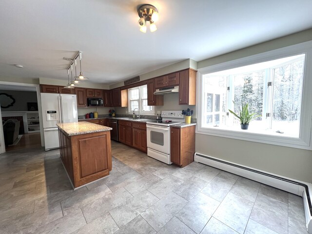 7 Edgewood Dr, Orono, ME 04473 - kitchen featuring white appliances, under cabinet range hood, a sink, a baseboard radiator, and a kitchen island