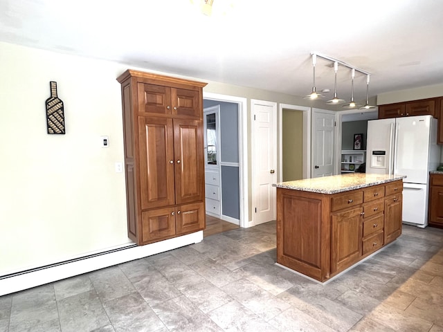 7 Edgewood Dr, Orono, ME 04473 - kitchen with white refrigerator with ice dispenser, stone finish flooring, baseboard heating, light stone counters, and brown cabinets