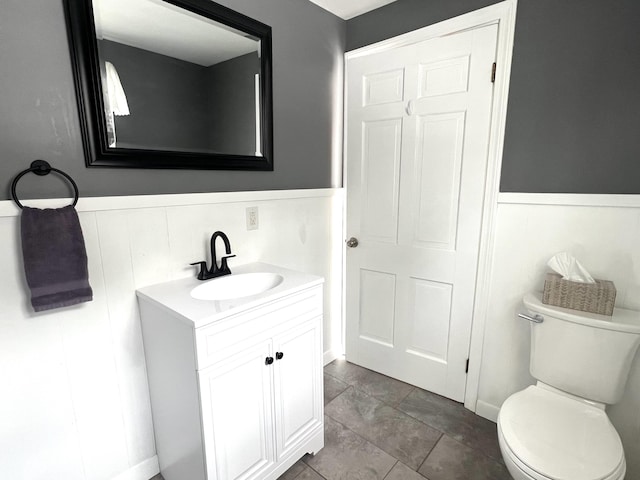 7 Edgewood Dr, Orono, ME 04473 - bathroom with vanity, wainscoting, and toilet