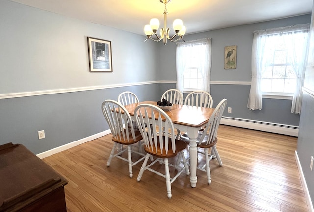 7 Edgewood Dr, Orono, ME 04473 - dining room with baseboard heating, a chandelier, wood finished floors, and baseboards