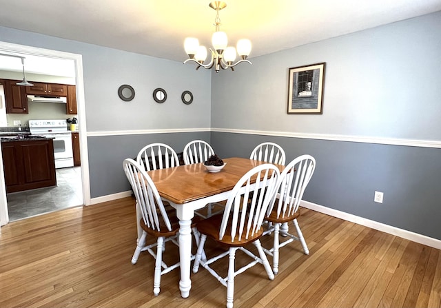 7 Edgewood Dr, Orono, ME 04473 - dining area with a chandelier, light wood finished floors, and baseboards