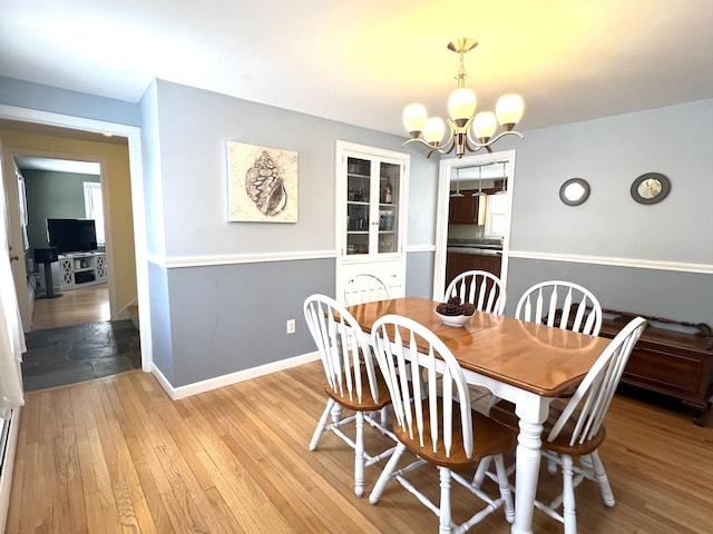 7 Edgewood Dr, Orono, ME 04473 - dining space with a chandelier, light wood finished floors, and baseboards
