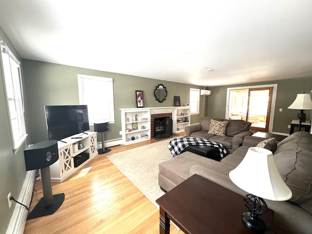 7 Edgewood Dr, Orono, ME 04473 - living room with a baseboard radiator, light wood-style floors, baseboards, and a brick fireplace