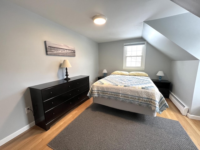 7 Edgewood Dr, Orono, ME 04473 - bedroom featuring a baseboard radiator, light wood finished floors, lofted ceiling, and baseboards
