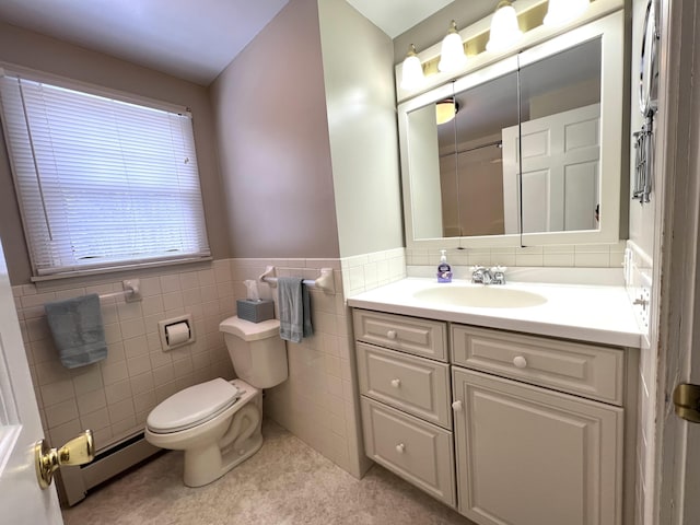 7 Edgewood Dr, Orono, ME 04473 - bathroom featuring toilet, a baseboard heating unit, vanity, tile walls, and wainscoting