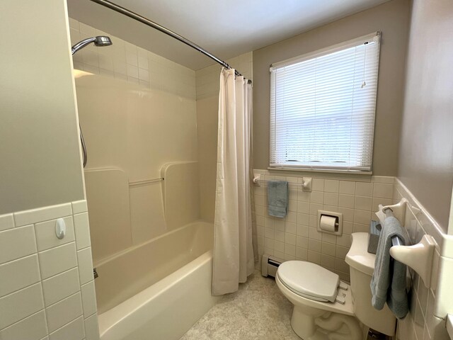 7 Edgewood Dr, Orono, ME 04473 - bathroom featuring tile walls, toilet, shower / tub combo with curtain, baseboard heating, and a wainscoted wall