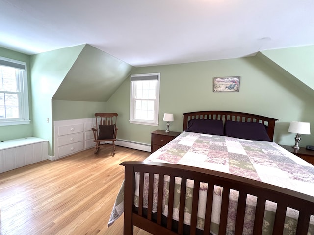 7 Edgewood Dr, Orono, ME 04473 - bedroom with baseboard heating, light wood finished floors, vaulted ceiling, and baseboards