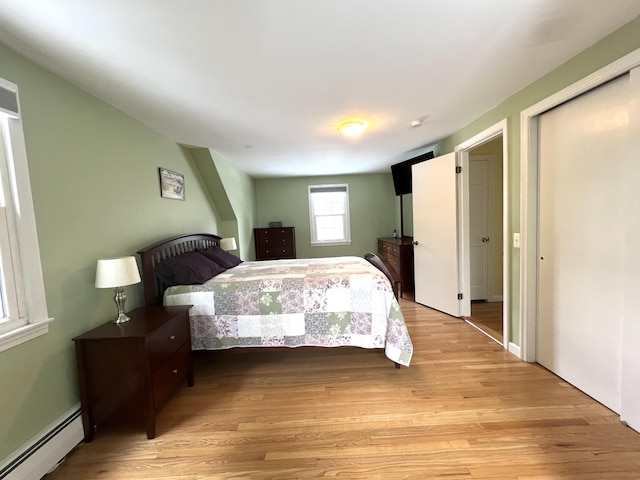 7 Edgewood Dr, Orono, ME 04473 - bedroom featuring a baseboard heating unit and light wood finished floors