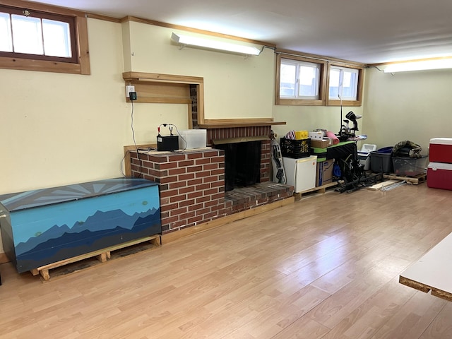 7 Edgewood Dr, Orono, ME 04473 - basement featuring wood finished floors, plenty of natural light, and a brick fireplace