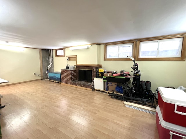 7 Edgewood Dr, Orono, ME 04473 - below grade area with a brick fireplace, plenty of natural light, and wood finished floors