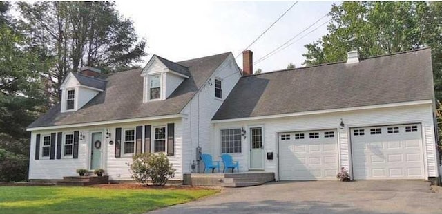 7 Edgewood Dr, Orono, ME 04473 - cape cod house with concrete driveway, an attached garage, a front yard, and a chimney