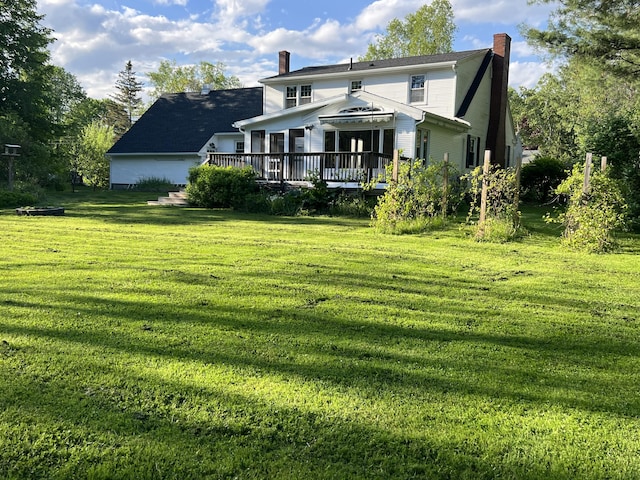 7 Edgewood Dr, Orono, ME 04473 - back of property featuring a chimney, a deck, and a yard