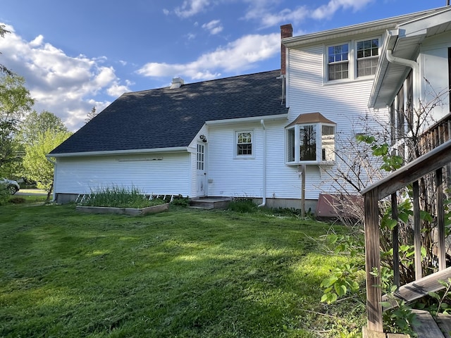 7 Edgewood Dr, Orono, ME 04473 - back of house with a chimney, a shingled roof, and a yard