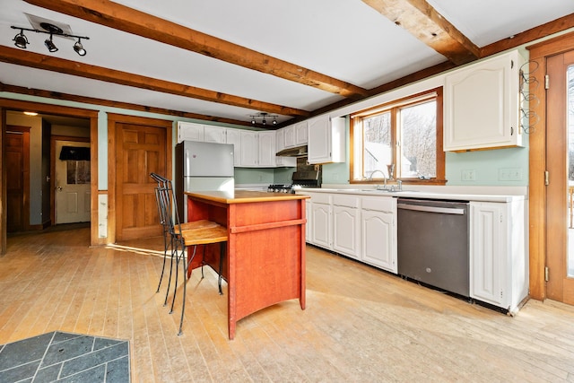 kitchen featuring a kitchen breakfast bar, white cabinets, light wood-type flooring, and appliances with stainless steel finishes