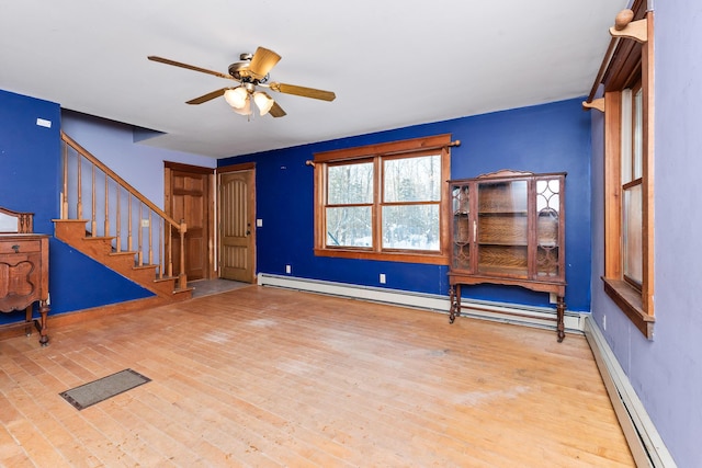 entryway with ceiling fan, light wood-type flooring, and a baseboard heating unit