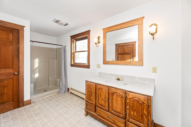 bathroom featuring baseboard heating, vanity, and walk in shower