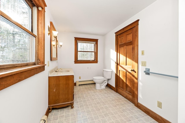 bathroom featuring vanity, toilet, a chandelier, and a baseboard heating unit