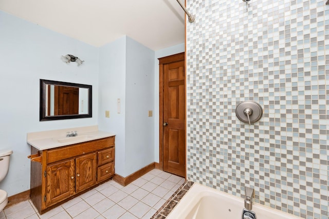 bathroom with tile patterned floors, vanity, toilet, and a bathing tub