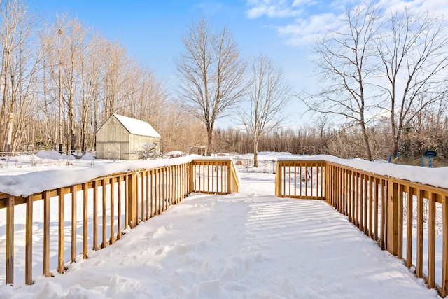 snow covered deck with an outdoor structure