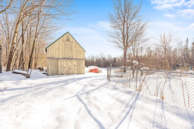 snowy yard with an outbuilding