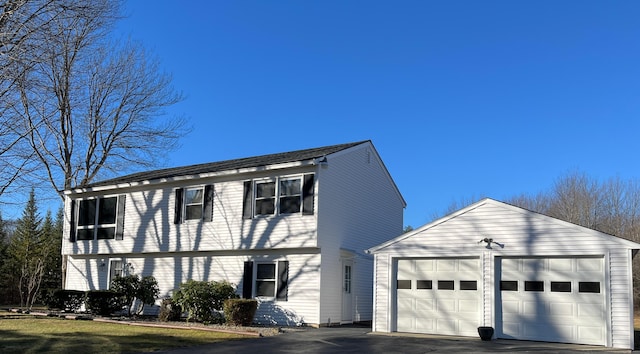 view of front of house featuring an outdoor structure and a garage