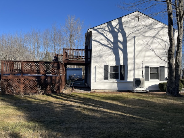 view of home's exterior with a lawn, ac unit, and a deck