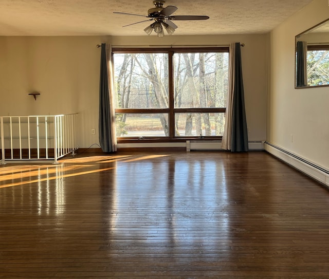 spare room with ceiling fan, dark hardwood / wood-style flooring, and a textured ceiling