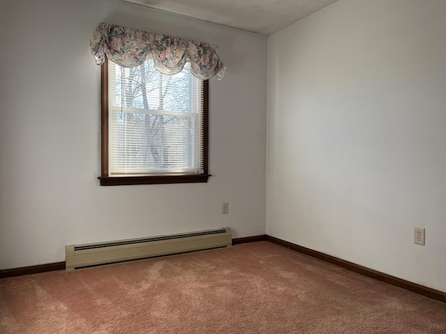 carpeted empty room featuring a baseboard radiator