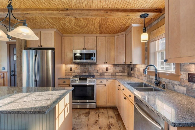 kitchen with hanging light fixtures, light brown cabinetry, sink, and appliances with stainless steel finishes